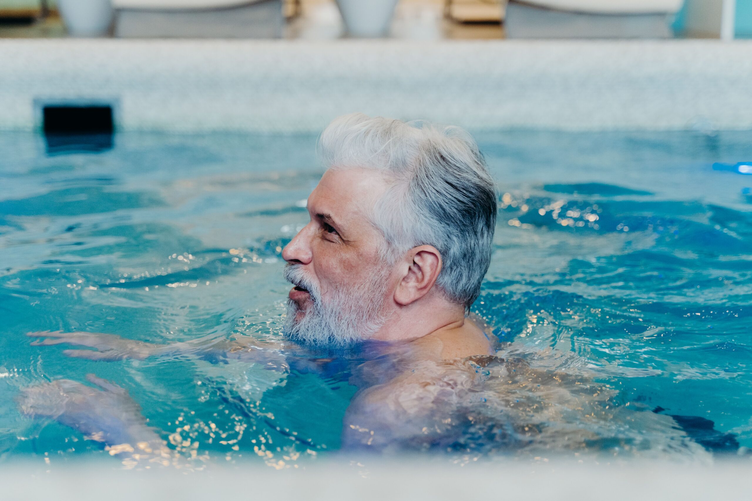 Senior doing gentle water aerobics in pool