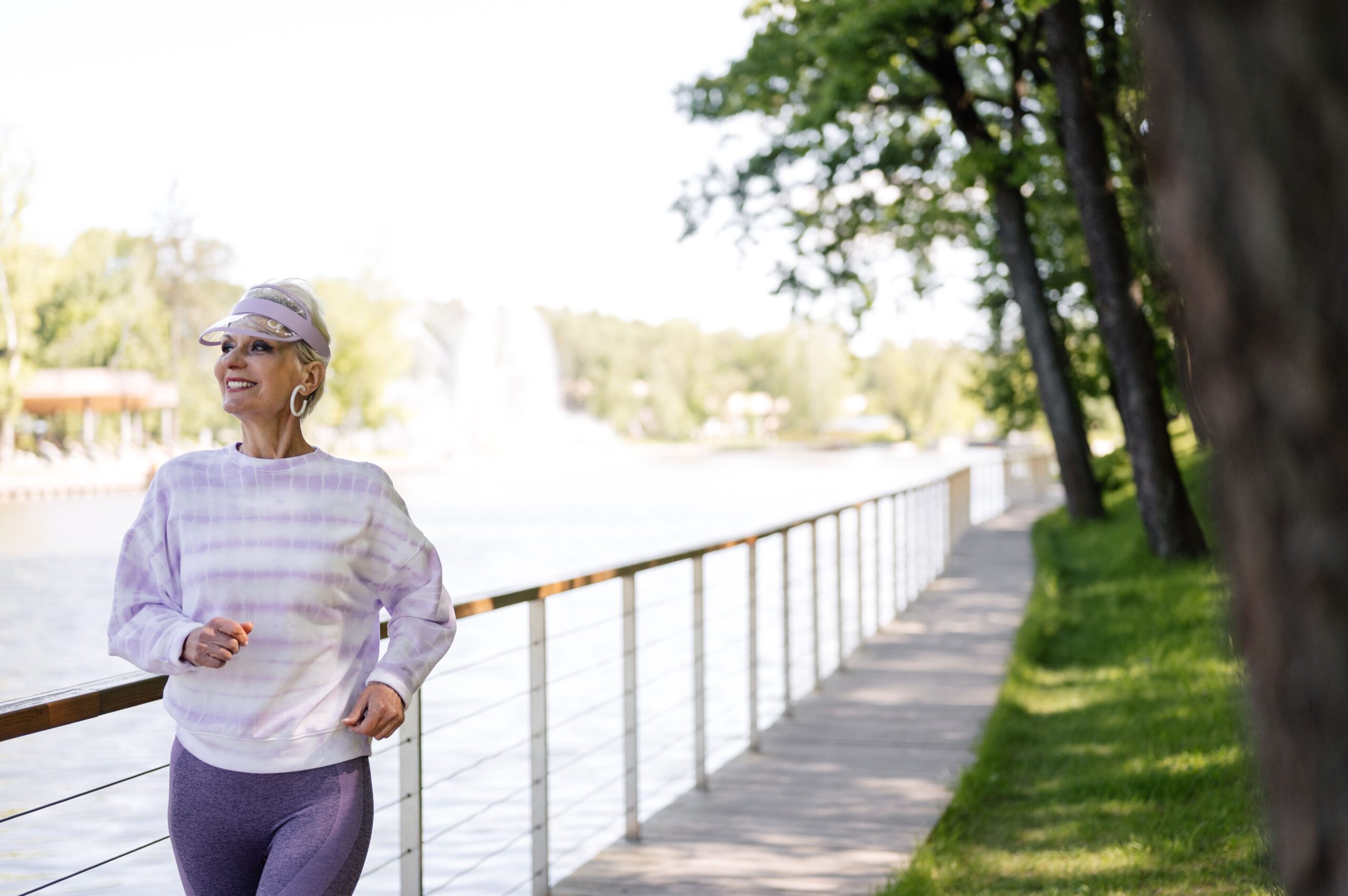 Senior doing low impact aerobic exercise, walking outdoors