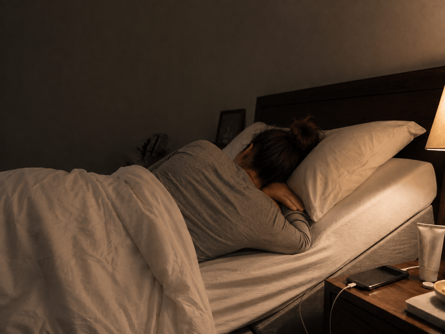 Person sleeping peacefully with the head of the bed raised for acid reflux relief