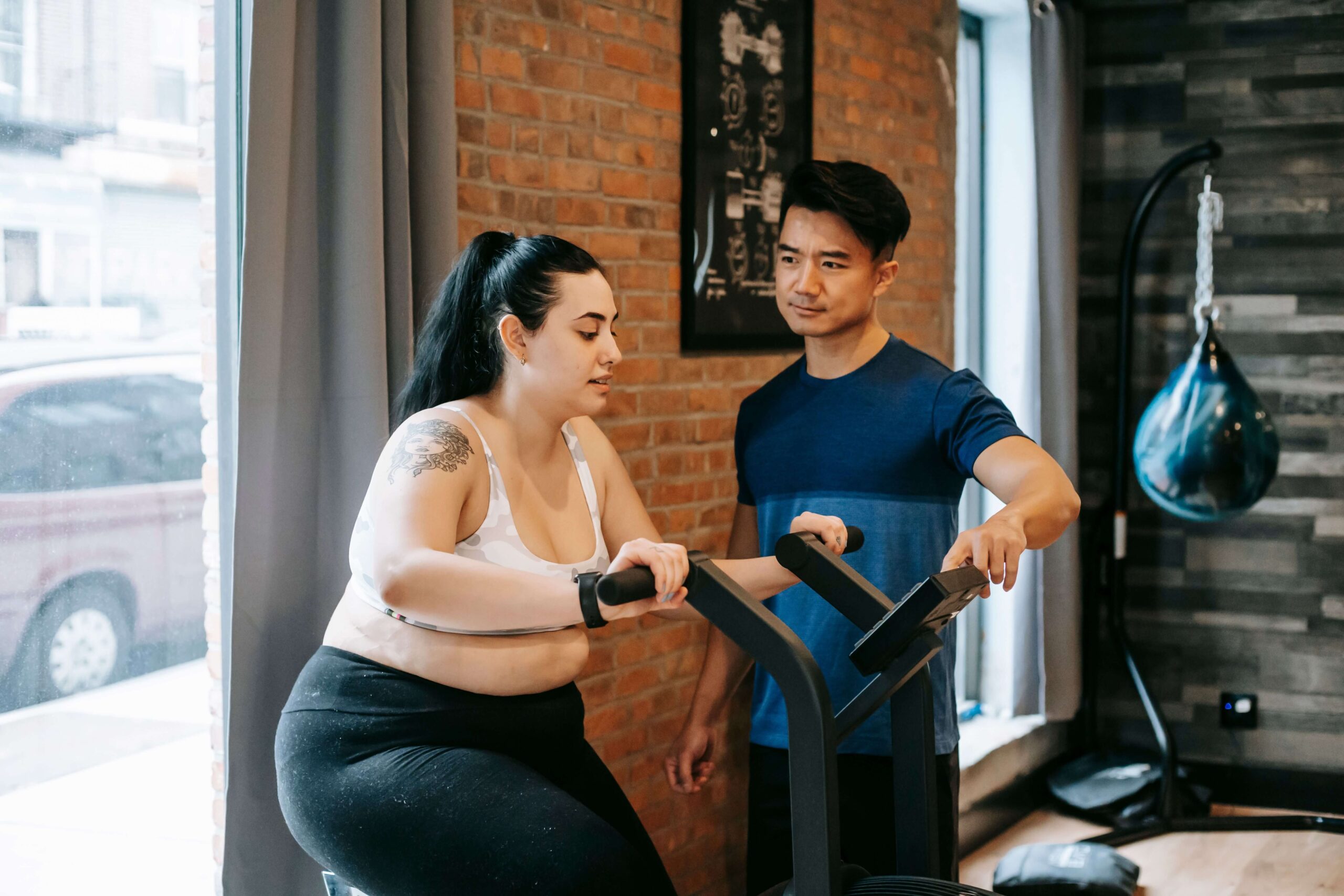 Person checking calorie and effort data mid-cycling session to confirm their bicycle workout for weight loss is in the fat-burning zone