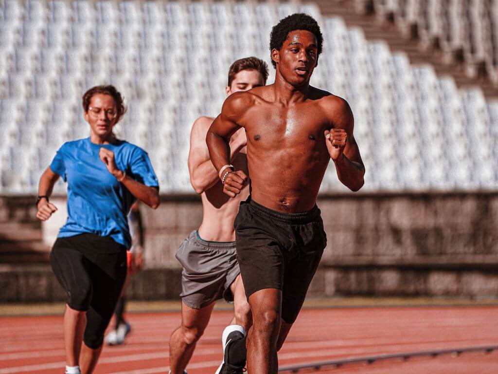 Person running outdoors as part of a military calisthenics style training session