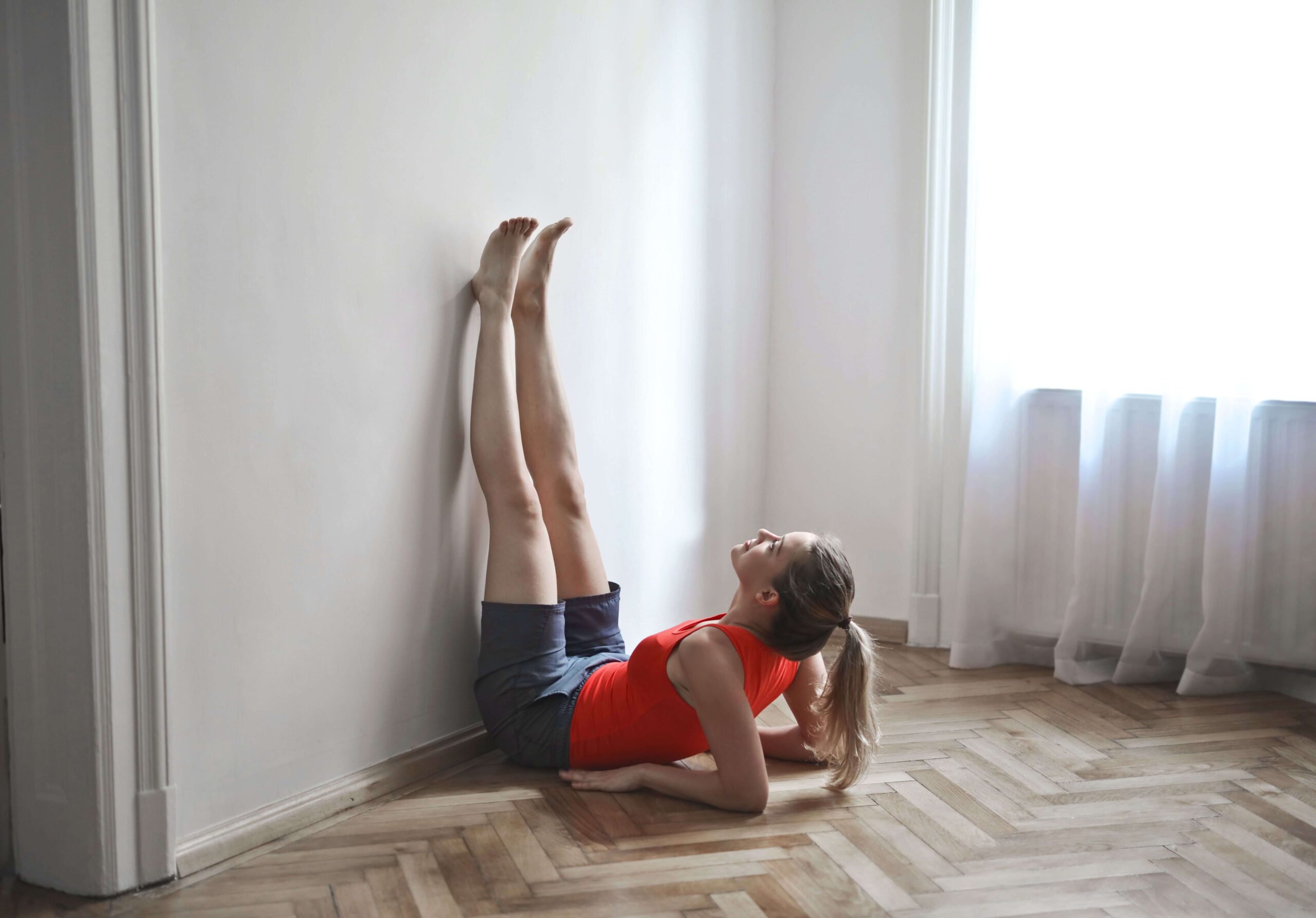 woman in legs-up-the-wall pose for circulation
